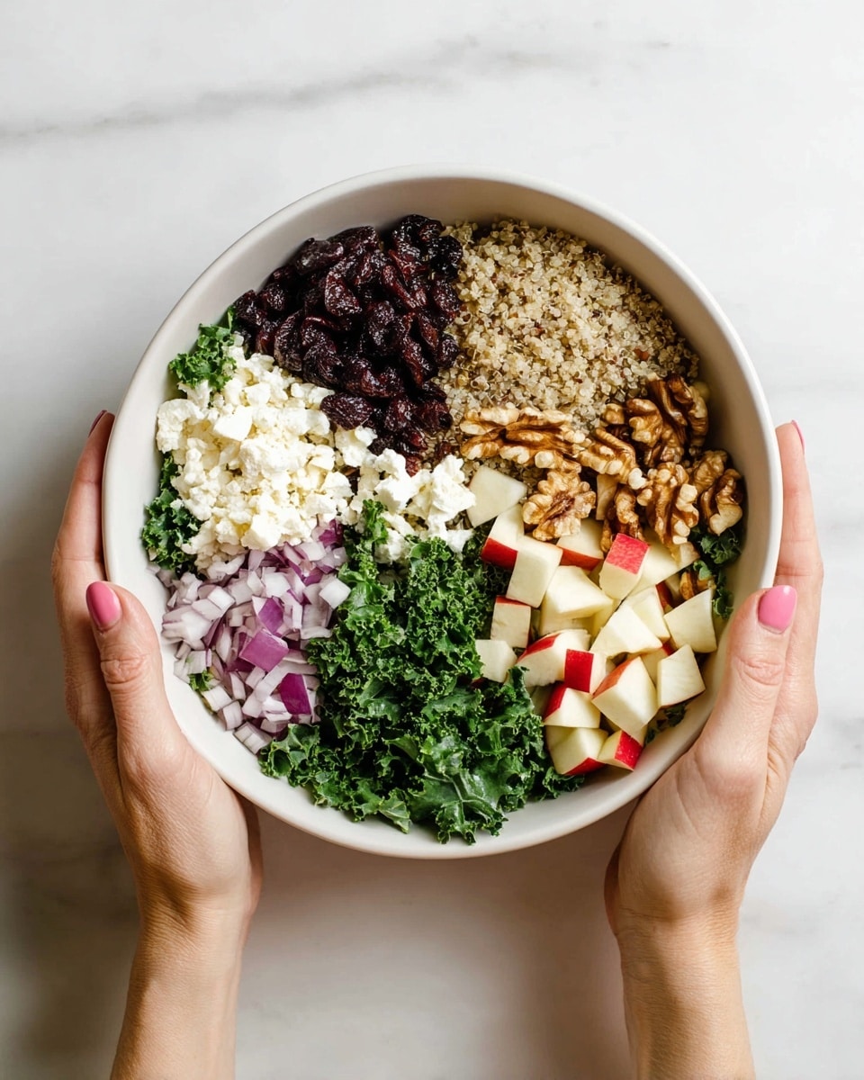 A white bowl filled with a colorful quinoa salad sitting on a white marbled surface. The salad has several layers starting with fluffy, light beige quinoa grains forming the base. Scattered throughout are small, bright green spinach leaves adding a fresh color contrast. On top, there are shiny red dried cranberries and crisp, light-colored apple chunks with red skin edges. White crumbled cheese is sprinkled generously across the salad, providing a soft texture. A wooden spoon rests inside the bowl, and a dark gray cloth is draped beside it. Photo taken with an iphone --ar 4:5 --v 7