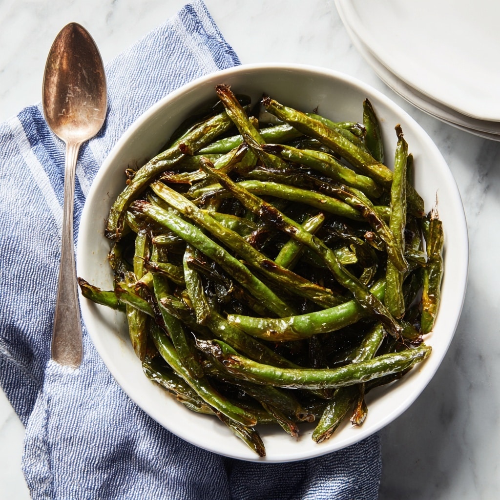 The image shows a white bowl filled with cooked green beans mixed with small pieces of crispy, reddish-brown bacon. The green beans are shiny, indicating they are coated with some oil or butter, and have a soft but still firm texture. The bacon pieces are scattered evenly throughout the green beans, adding a contrast in color and texture. The bowl sits on a white marbled surface. photo taken with an iphone --ar 4:5 --v 7