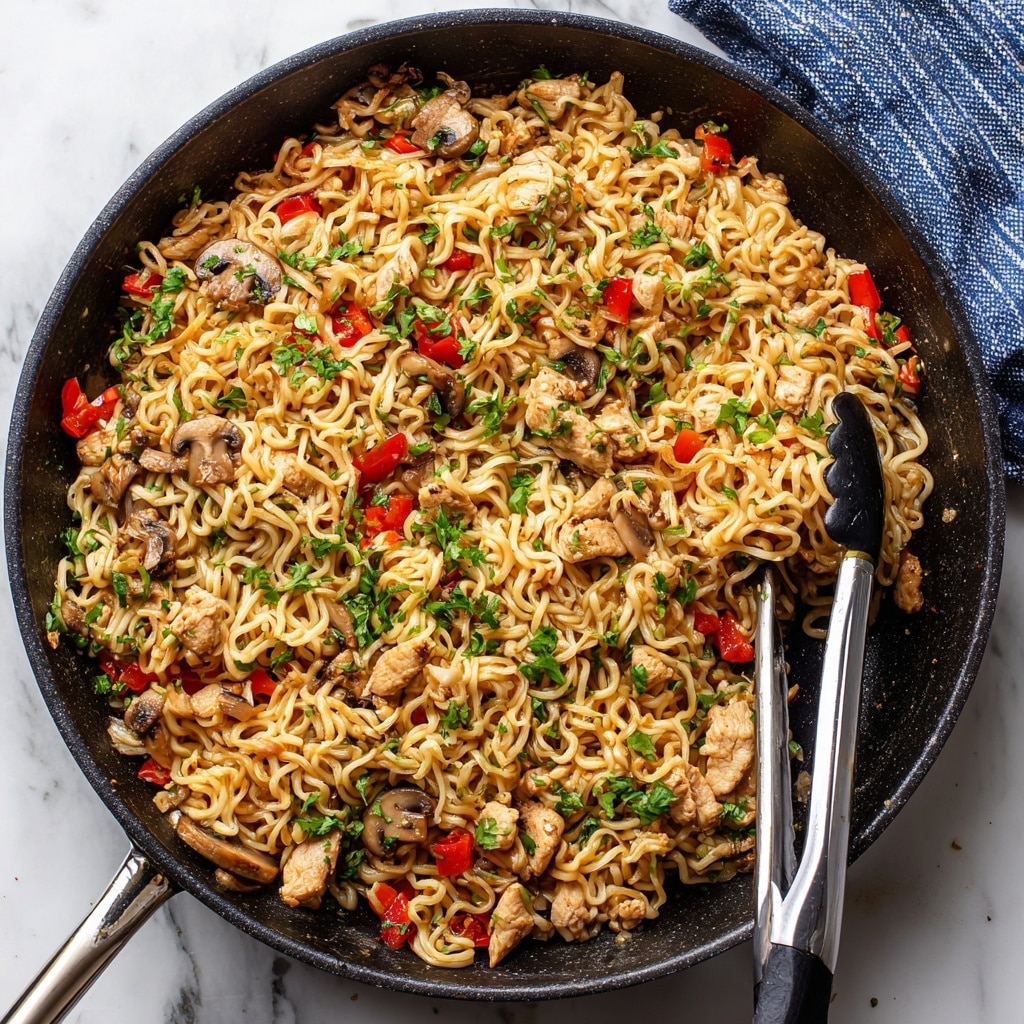 A close-up view of a black bowl filled with three clear layers of stir-fried noodles, chicken pieces, and vegetables. The bottom layer shows curly, golden-brown noodles, coated lightly in sauce. The middle layer features small chunks of cooked chicken with a light golden color, mixed evenly with diced orange red bell peppers. The top layer is sprinkled with chopped green onions and fresh green herbs, adding a bright contrast. The bowl rests on a white marbled surface with soft natural light, enhancing the warm colors of the dish. photo taken with an iphone --ar 4:5 --v 7