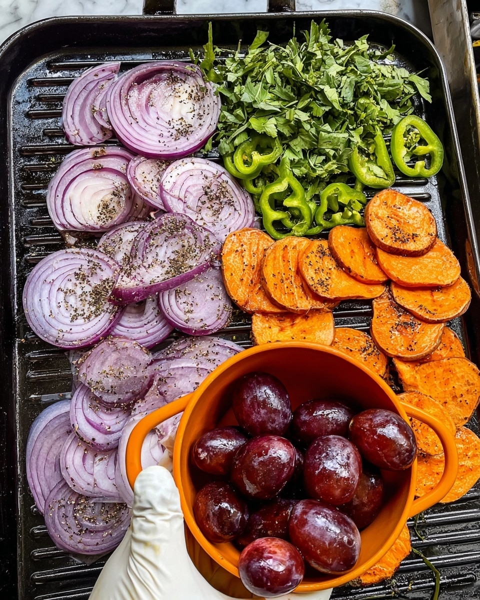 A metal baking tray is filled with a colorful mix of roasted sweet potato wedges, deep purple-red grapes, and thin slices of red onion. The sweet potato wedges are a warm orange color with a slightly crispy texture, spread evenly across the tray. The grapes are plump and glossy, scattered between the wedges, while the red onion slices are curled and soft, adding a touch of purple throughout. Small green herb leaves are sprinkled on top, giving a fresh contrast to the warm tones. A metal spatula lies inside the tray, partially under some of the vegetables. The tray rests on a wooden surface replaced by a white marbled texture. photo taken with an iphone --ar 4:5 --v 7