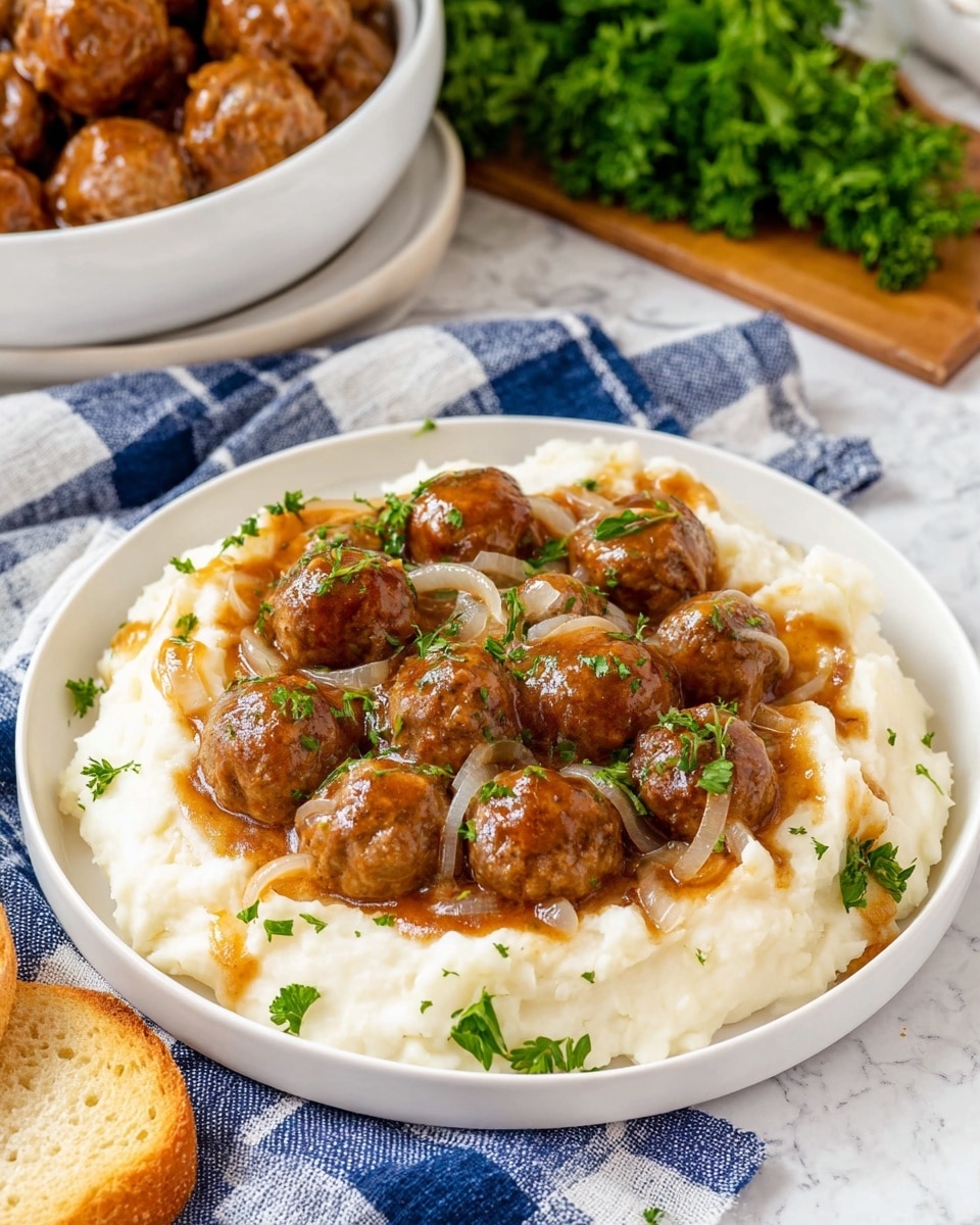 The image shows a close-up of a slow cooker filled with meatballs in sauce, partly covered with melted cheese. On the left side, the meatballs are layered with a generous melting layer of white cheese topping, slightly browned and mixed with small bits of green herbs. On the right side, plain brown meatballs sit in a rich, glossy brown sauce with visible sliced onions. A wooden spoon rests on the right edge of the slow cooker, partly underneath some meatballs. The background is a white marbled texture. Photo taken with an iphone --ar 4:5 --v 7