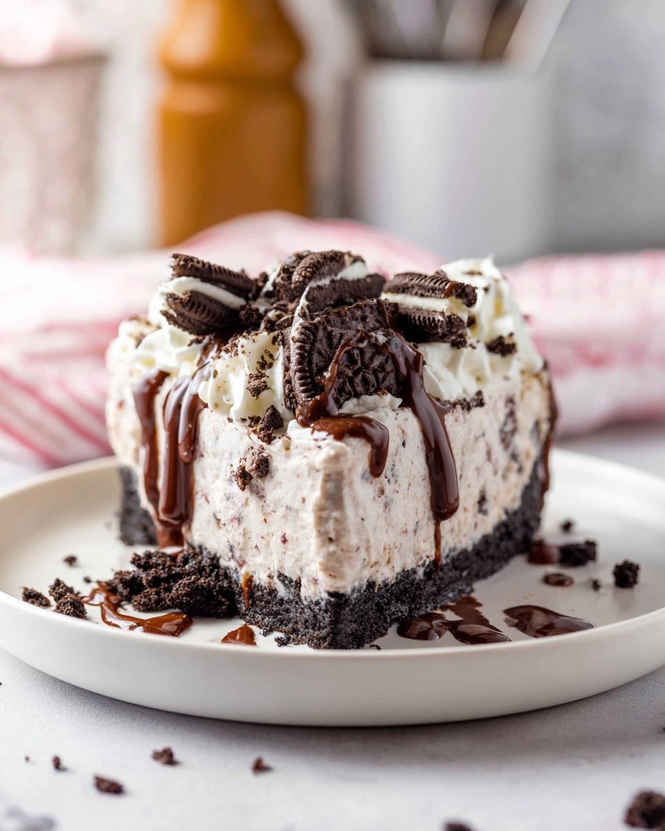A slice of cookies and cream pie is shown on a stack of two white plates placed on a wooden surface with a white marbled texture background. The pie has three main layers: a dark chocolate cookie crust at the bottom, a thick light beige creamy filling speckled with crushed cookie pieces in the middle, and a topping of whipped cream on top. The whipped cream is decorated with chunks of crushed chocolate sandwich cookies. Chocolate syrup is drizzled over the top edge down the sides, adding a glossy texture. The overall look is rich and creamy with contrasting dark cookie bits. Photo taken with an iphone --ar 4:5 --v 7