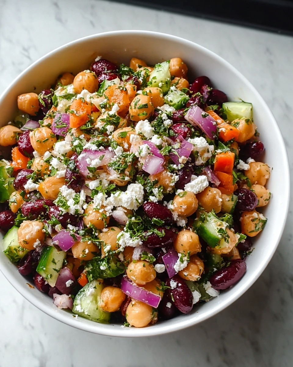 The dish is served on a white plate showing a toasted thick bread slice at the bottom with a golden brown crust. On top, there is a layer of creamy white cheese spread, followed by orange chickpeas scattered evenly. Over the chickpeas, there are small cubes of bright pink pickled onions and finely chopped fresh green herbs. The whole dish is garnished with thin strands of dark purple or black seaweed pieces, adding texture and contrast. The plate sits on a white marbled surface near a window with soft natural light. A woman's hand is about to reach for the plate from the side. Photo taken with an iphone --ar 4:5 --v 7
